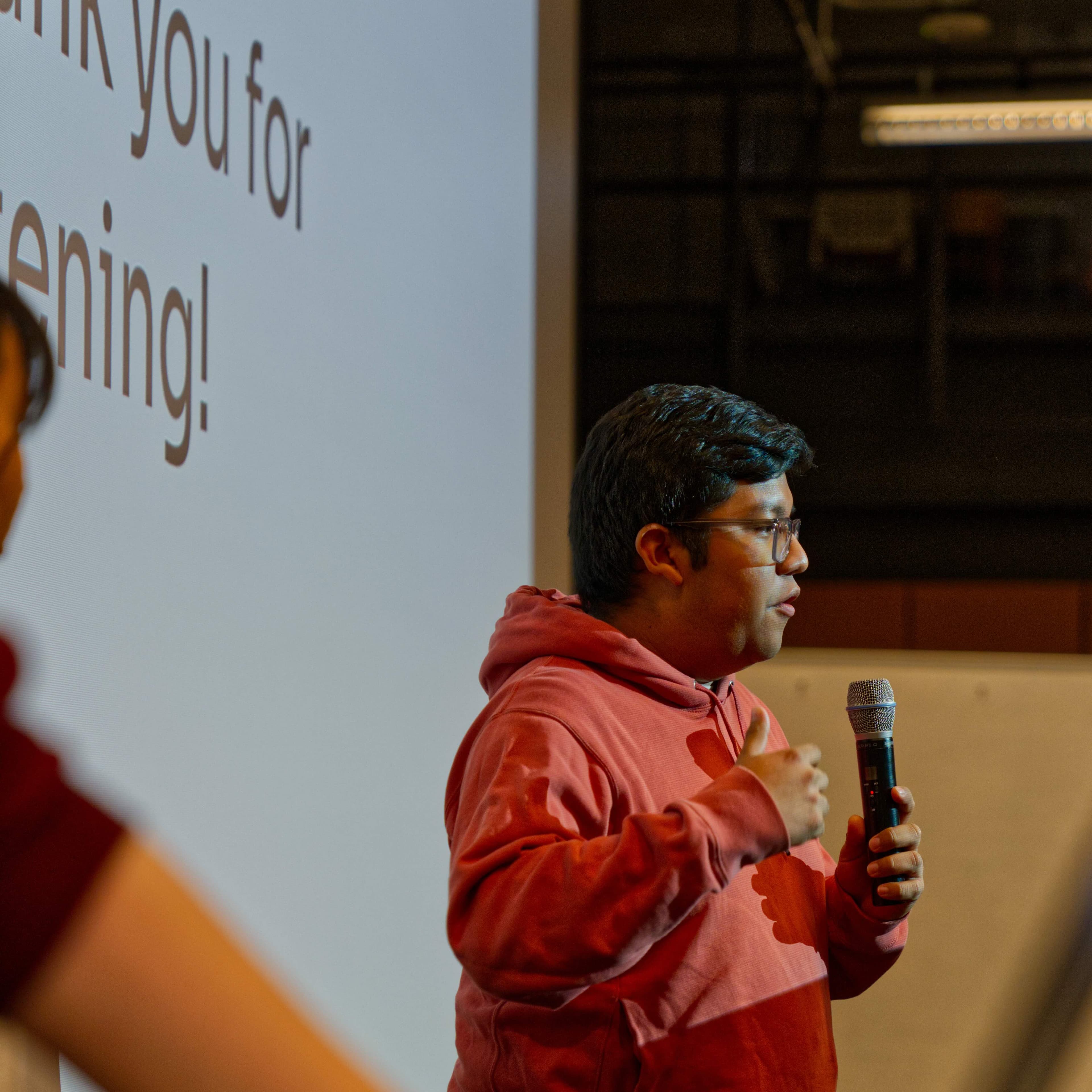 Daniel Luna giving a presentation at the end of a hackathon.